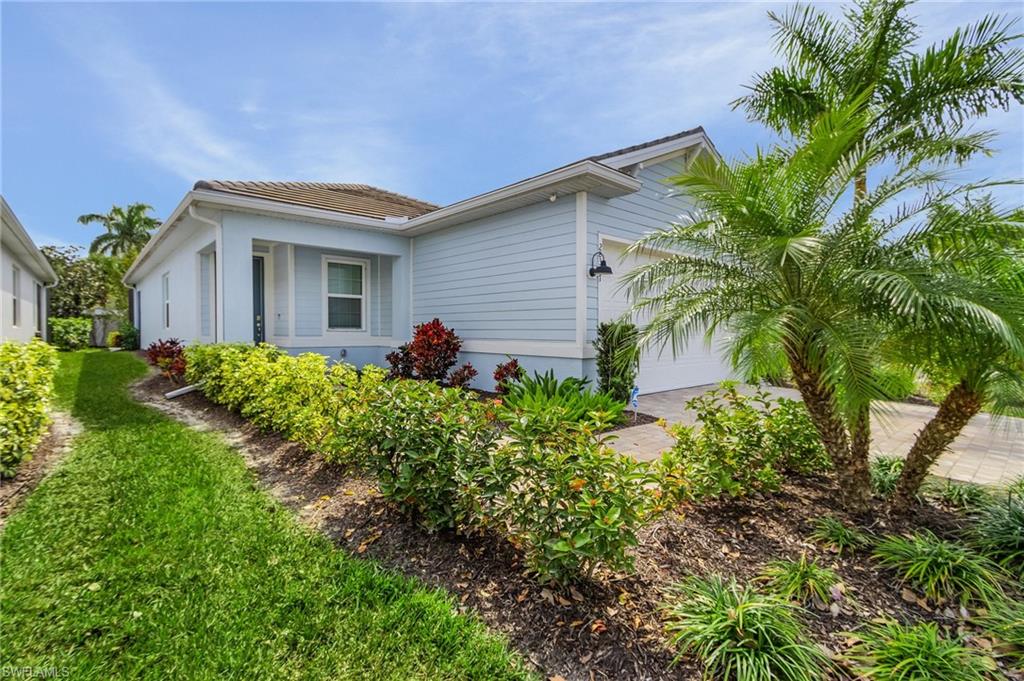 28367 Captiva Shell Loop Bonita Springs, FL 34135 - Photo 6 of 36 a front view of house with yard and green space