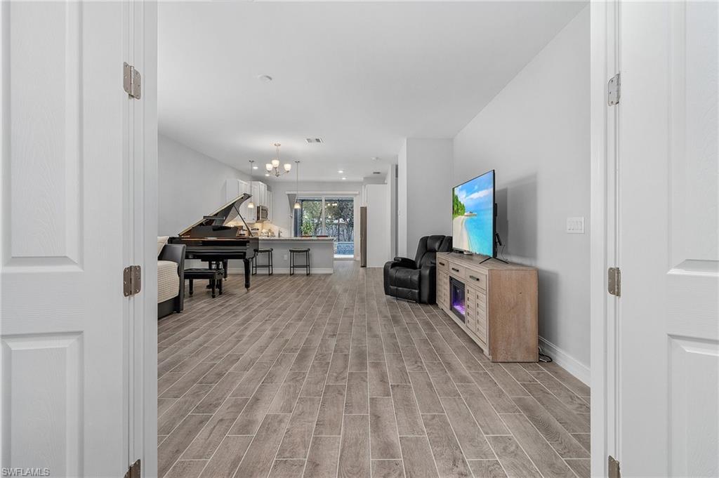 28367 Captiva Shell Loop Bonita Springs, FL 34135 - Photo 9 of 36 a living room with furniture and a flat screen tv
