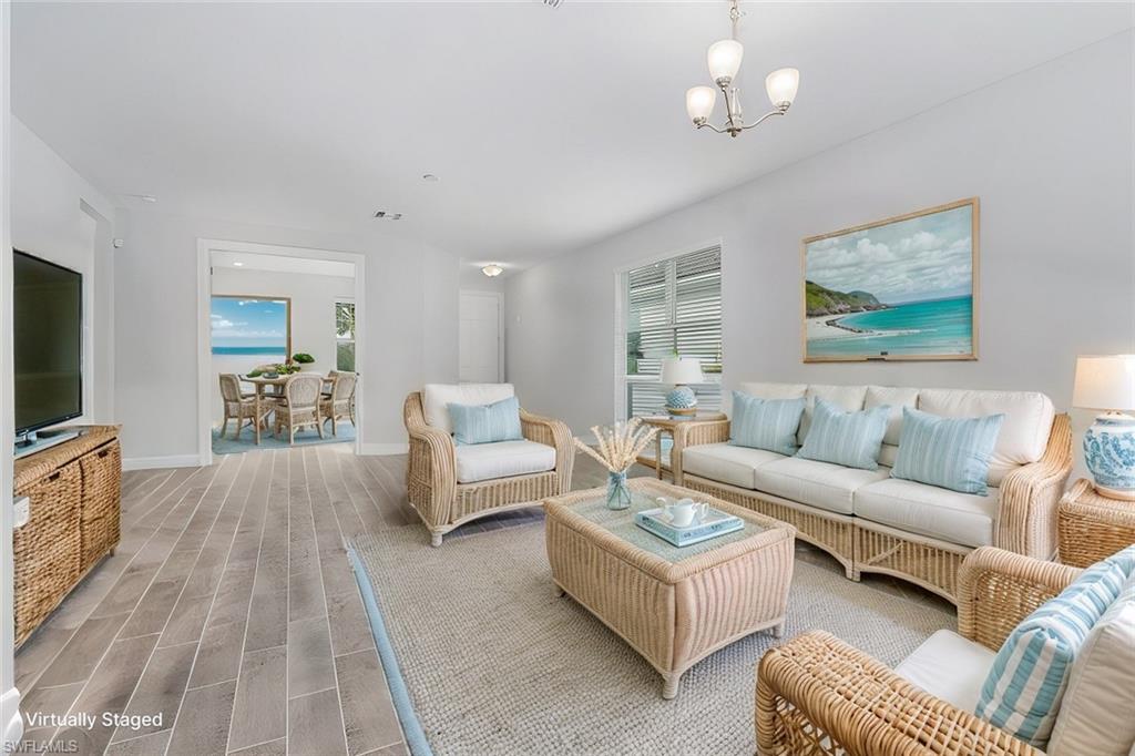 28367 Captiva Shell Loop Bonita Springs, FL 34135 - Photo 10 of 36 a living room with furniture wooden floor and a flat screen tv