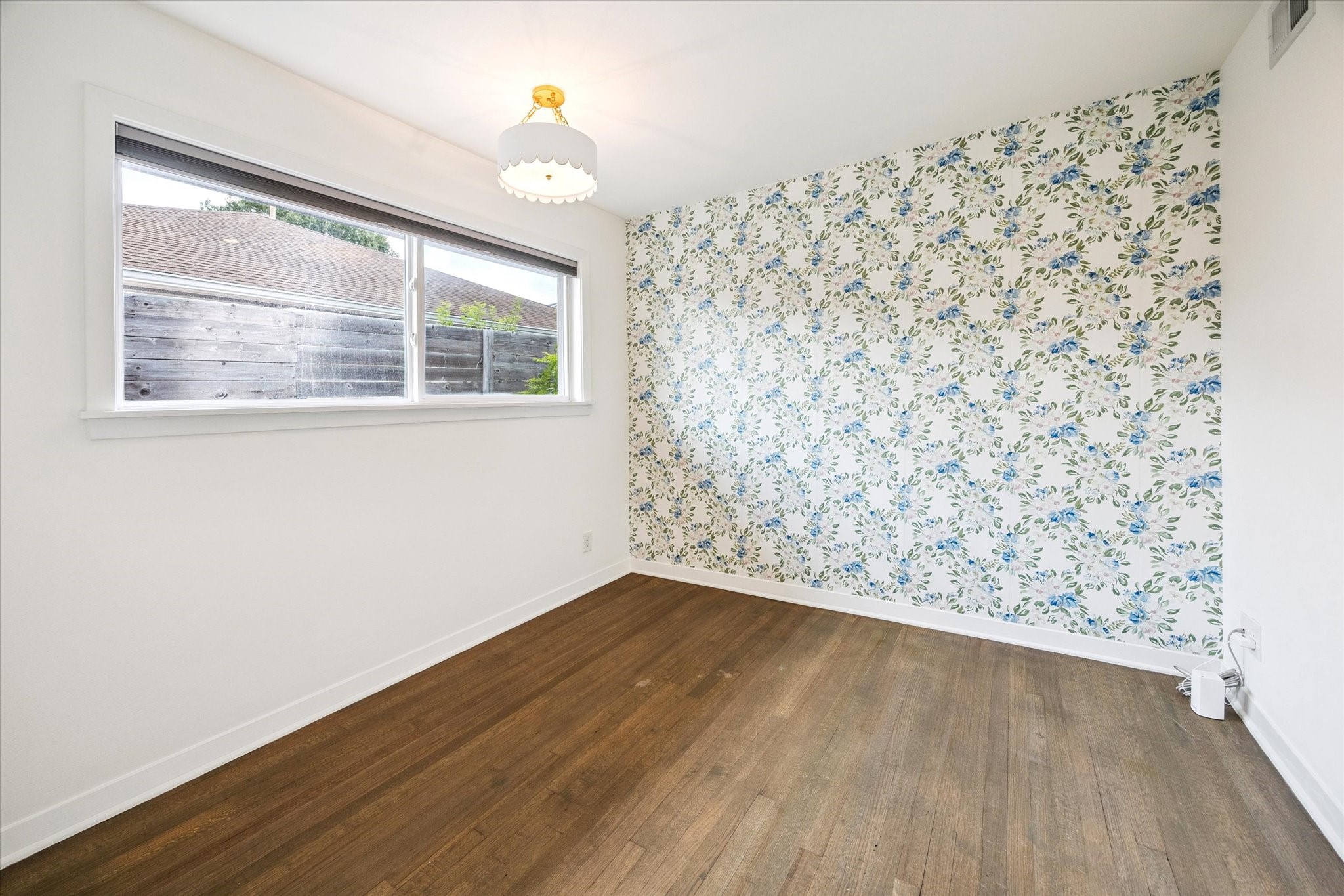 5231 Lamonte Lane Houston, TX 77092 - Photo 30 of 41 a view of an empty room with wooden floor and a window