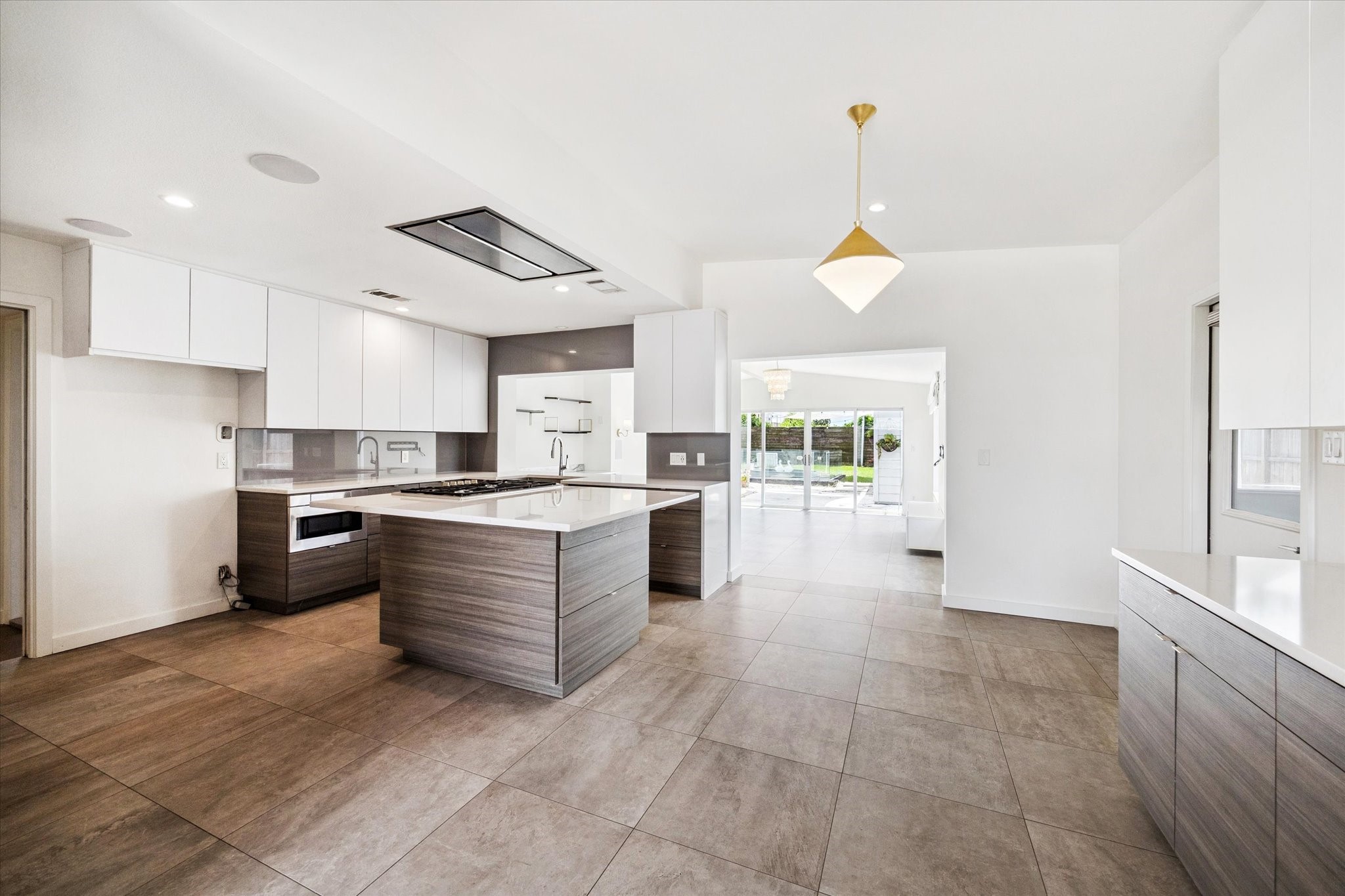 5231 Lamonte Lane Houston, TX 77092 - Photo 10 of 41 a large kitchen with kitchen island granite countertop a stove a sink a counter space and cabinets
