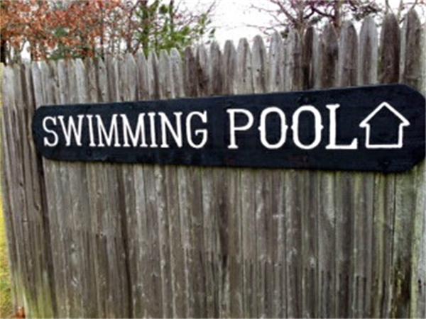 71 Round House Road, Unit 71 Bourne, MA 02532 - Photo 23 of 25 a street sign under a wooden fence