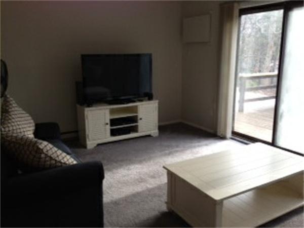 71 Round House Road, Unit 71 Bourne, MA 02532 - Photo 7 of 25 a living room with furniture and a flat screen tv