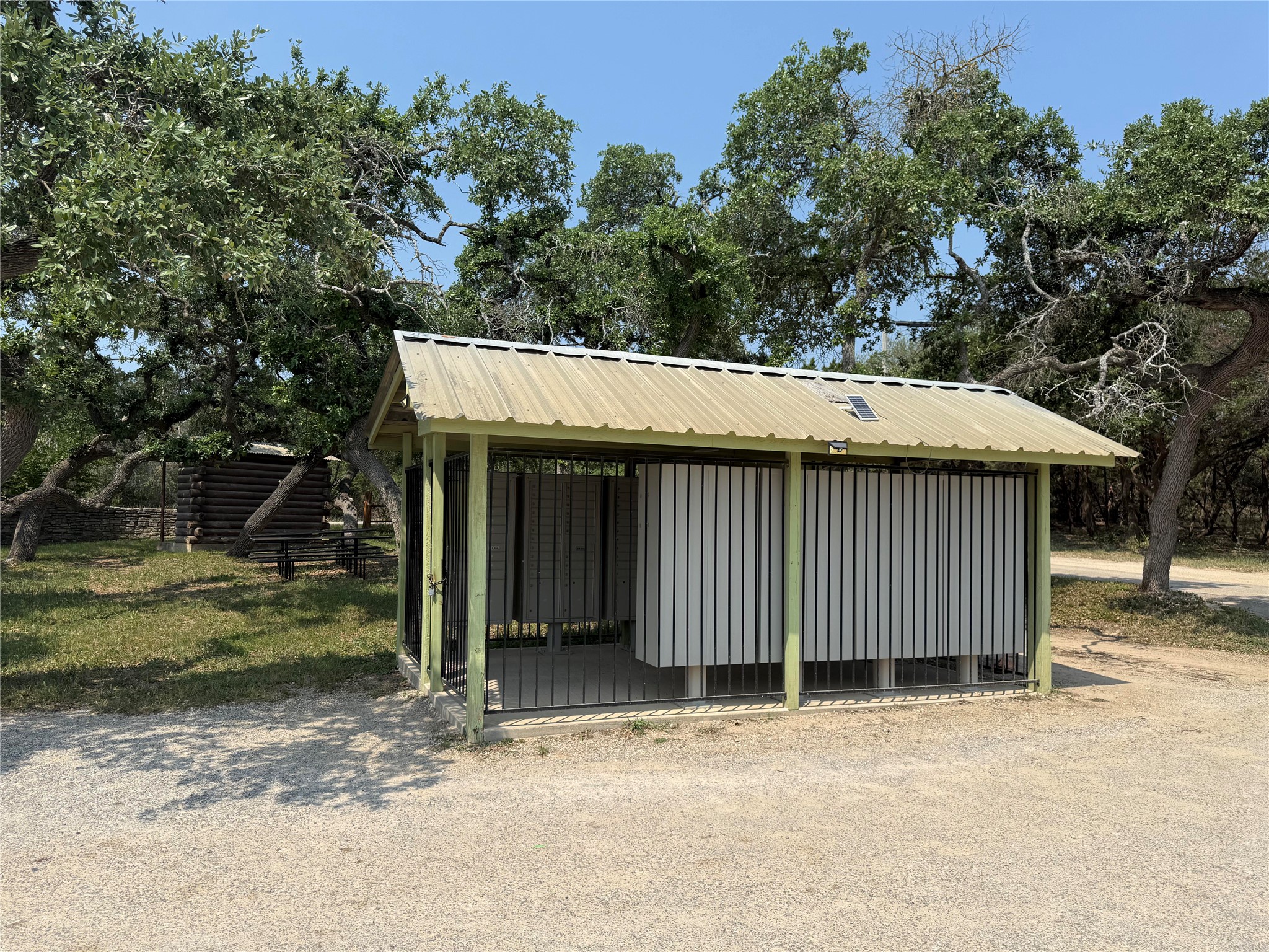 Lot 100-3 South Rainbow Ranch Road Wimberley, TX 78676 - Photo 11 of 11 a view of a house with a yard and garage