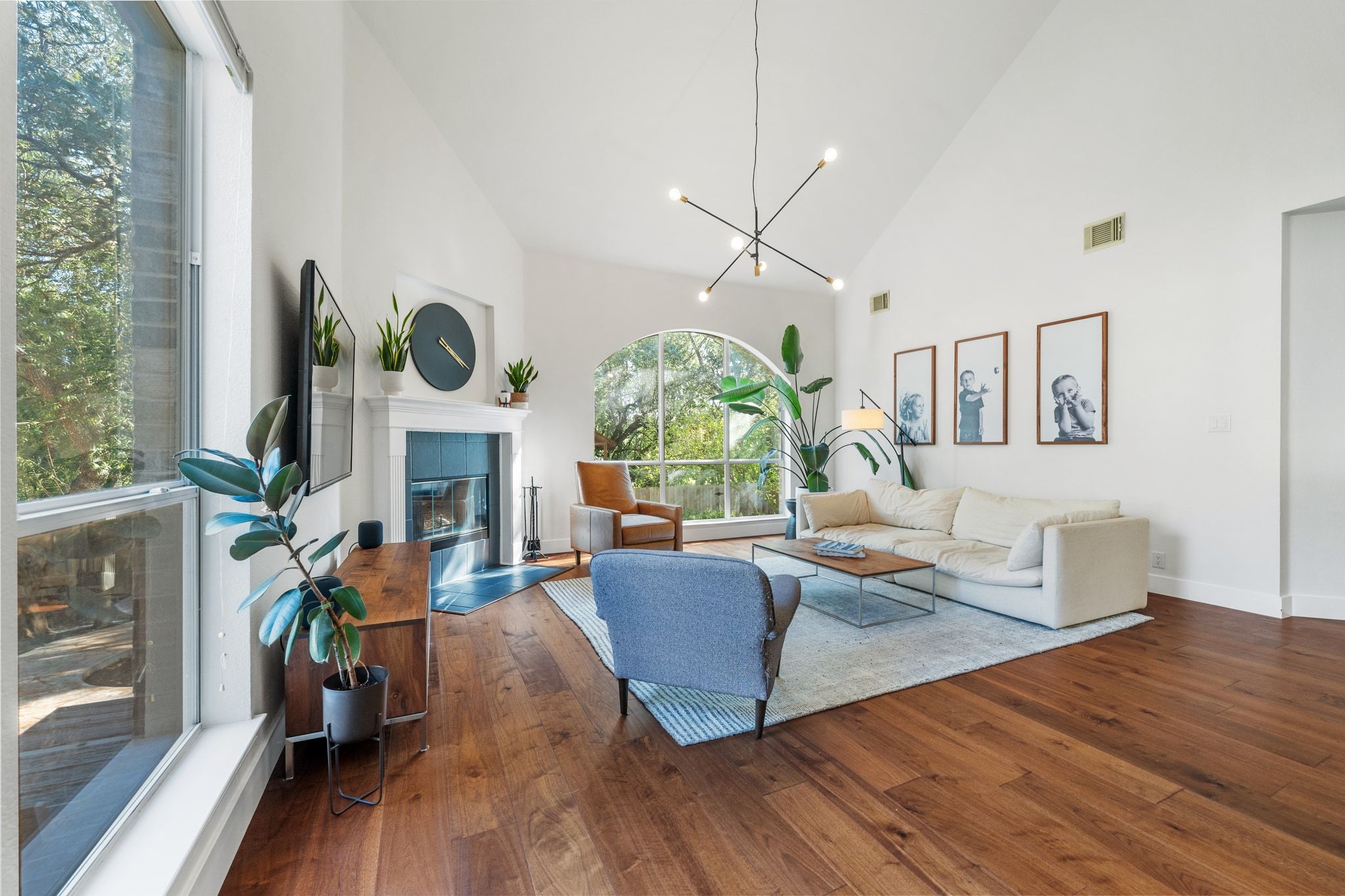 a living room with fireplace furniture and a large window