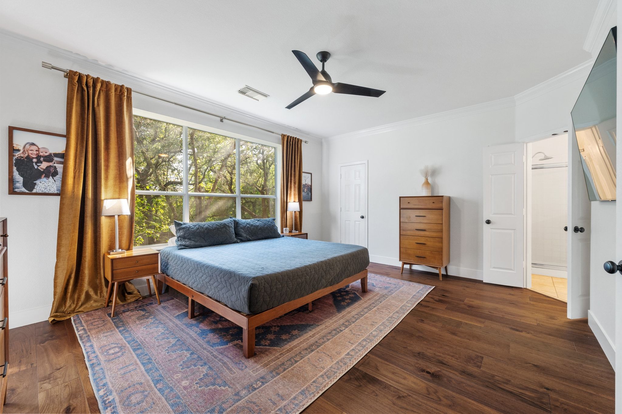 3417 Grimes Ranch Road Austin, TX 78732 - Photo 17 of 40 a bedroom with a bed and wooden floor