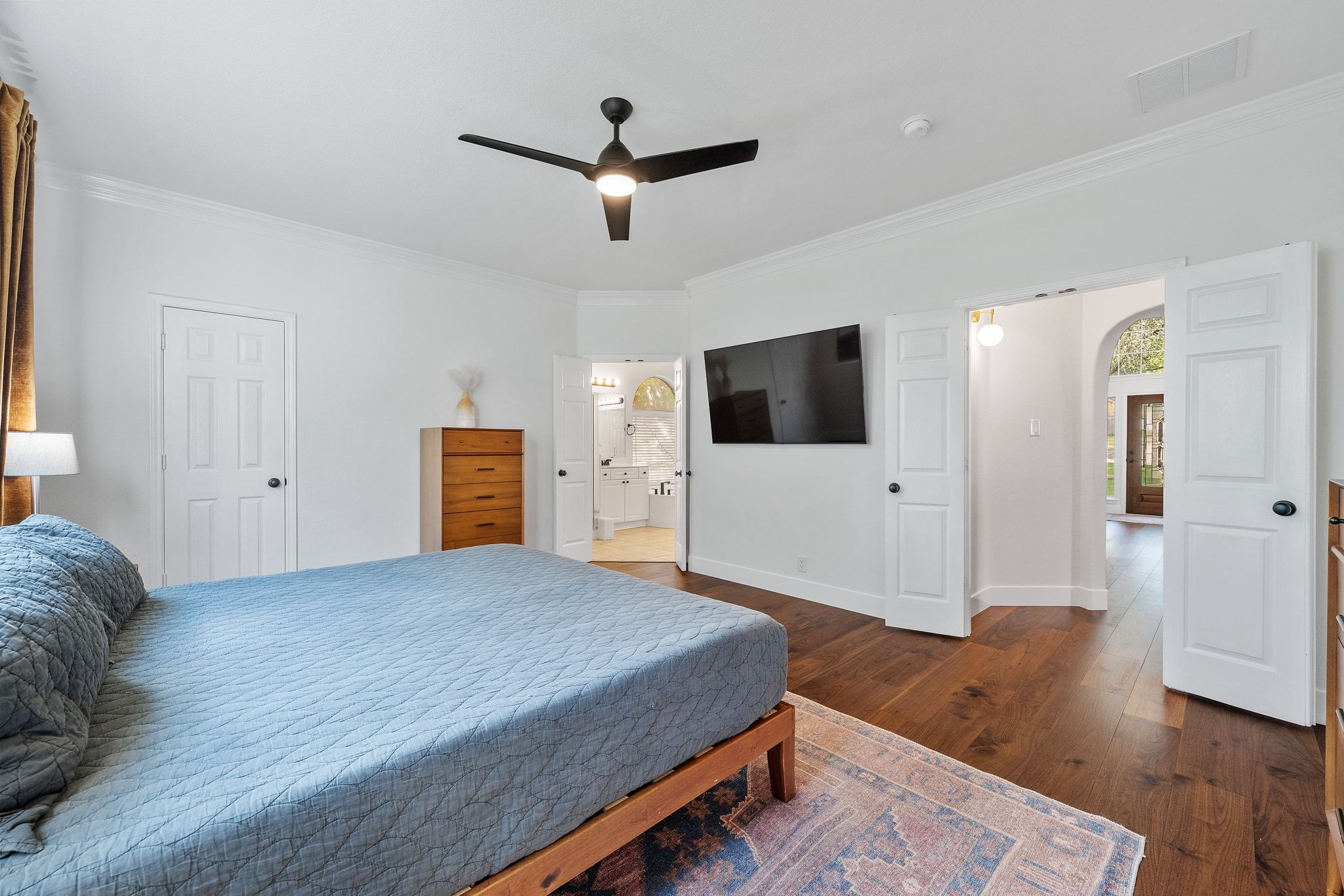 3417 Grimes Ranch Road Austin, TX 78732 - Photo 19 of 40 a bedroom with a bed and a flat screen tv