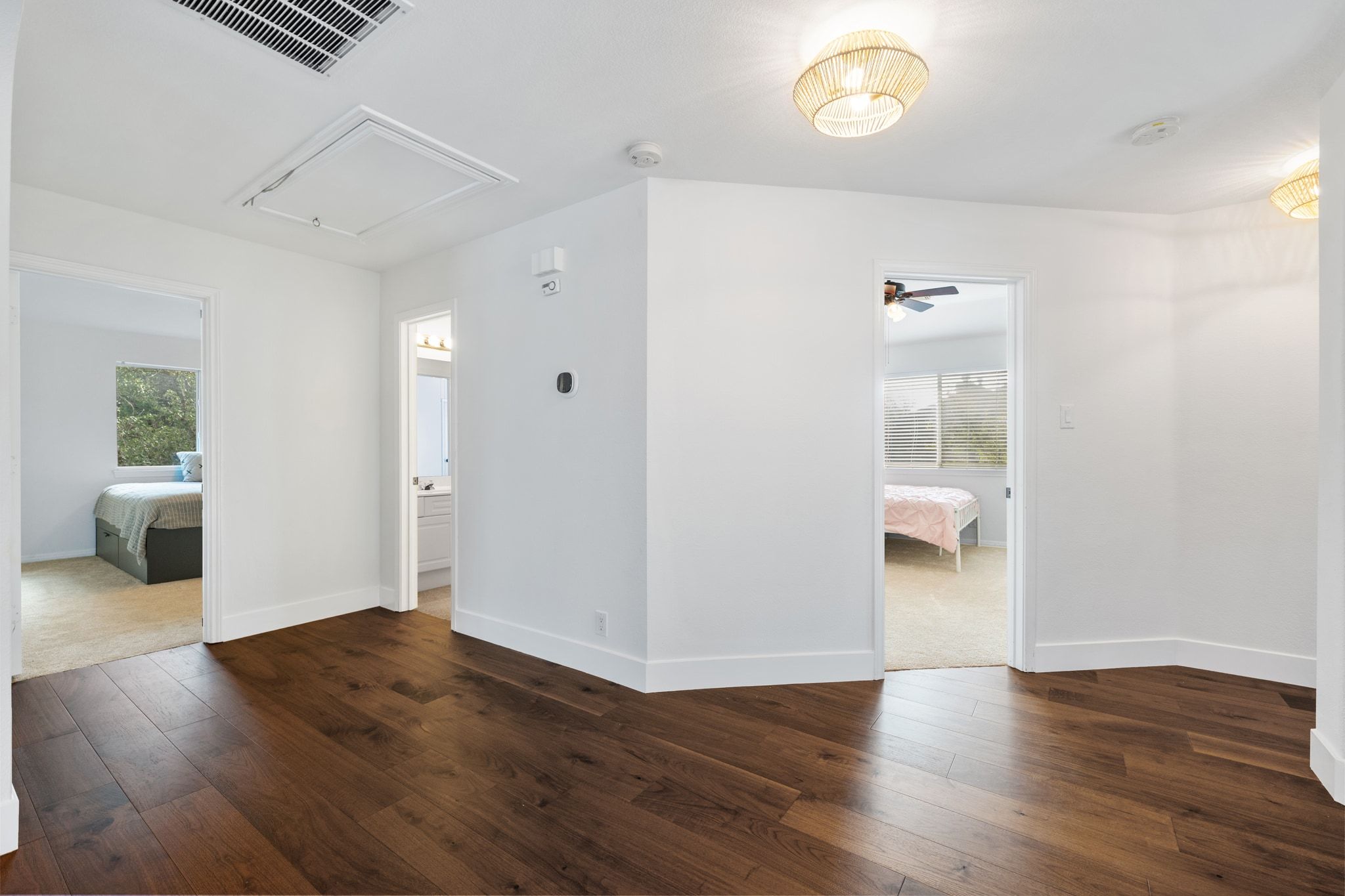 3417 Grimes Ranch Road Austin, TX 78732 - Photo 26 of 40 a view of a hallway with wooden floor and a bathroom