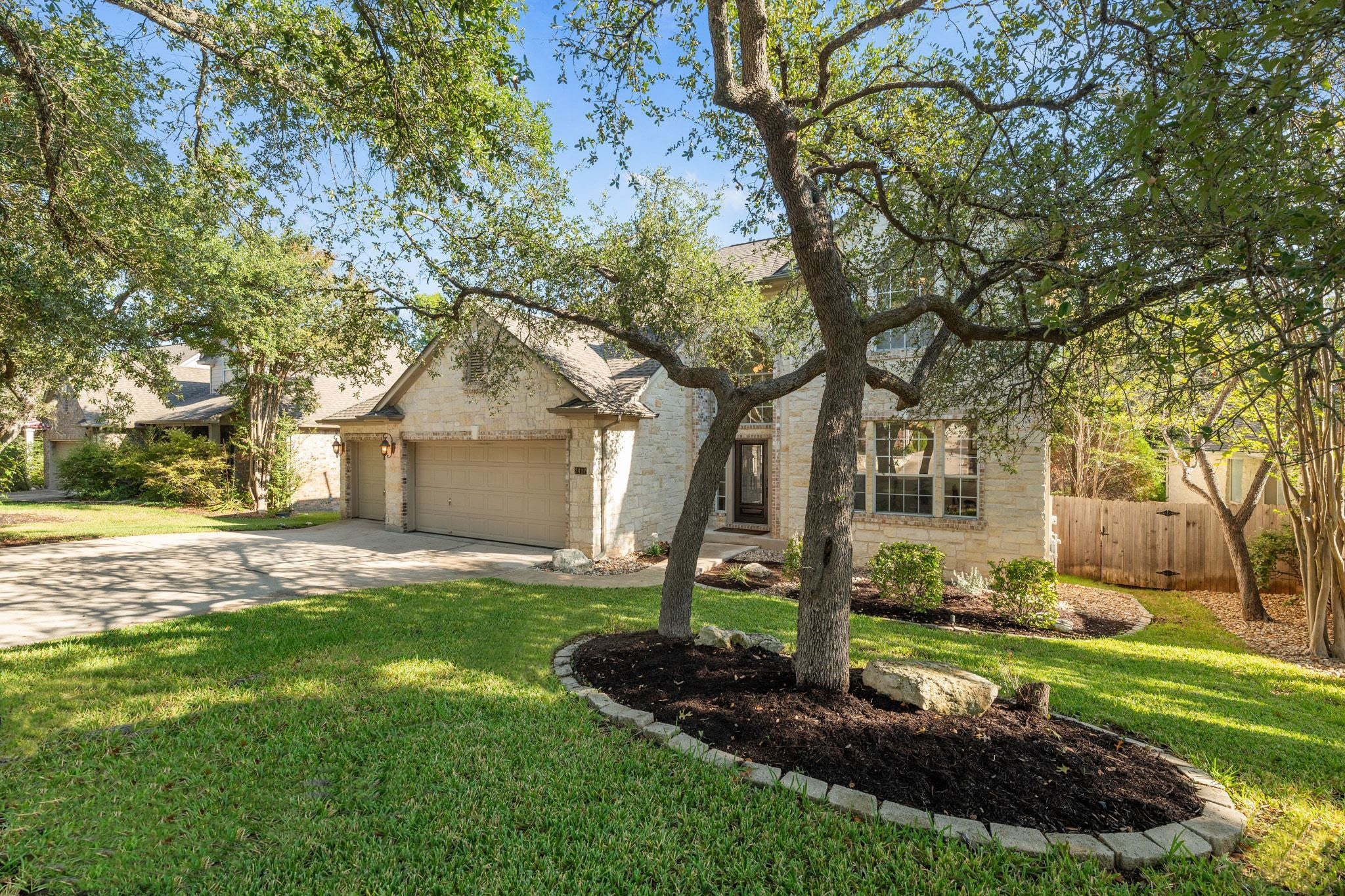 3417 Grimes Ranch Road Austin, TX 78732 - Photo 40 of 40 a front view of a house with a yard and garage