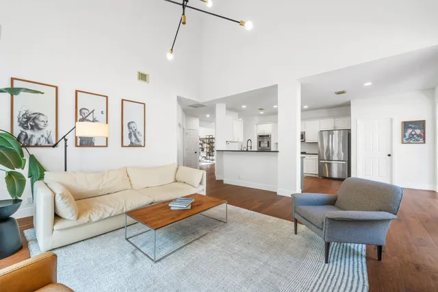 a large kitchen with stainless steel appliances and a sink