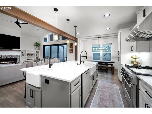 a large white kitchen with a stove and a sink