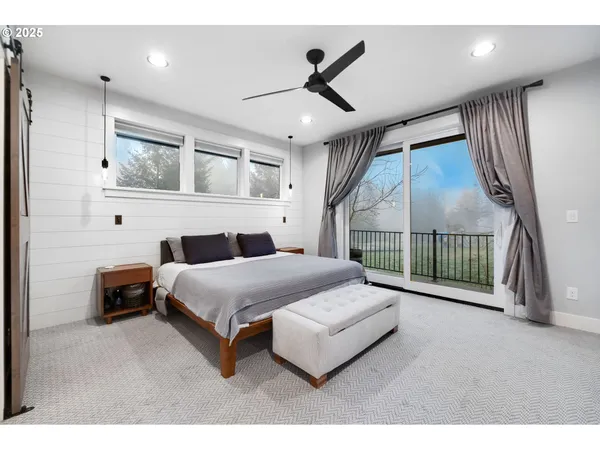 a bed room with a bed and a ceiling fan