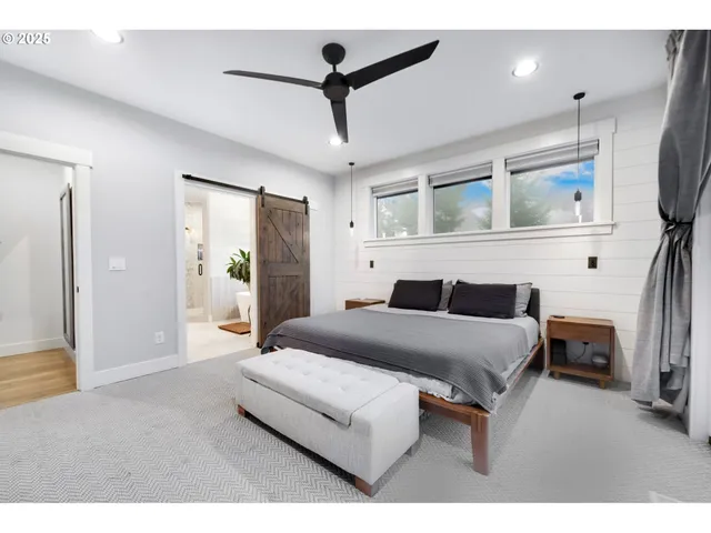 a bedroom with a bed a mirror and lamp