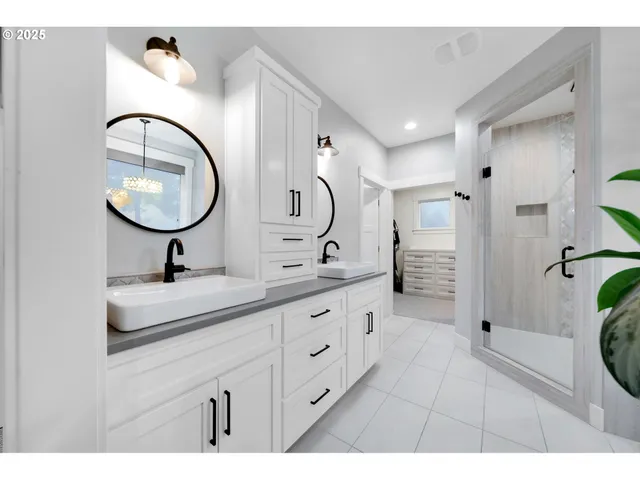 a bathroom with a double vanity sink a toilet a mirror and vanity