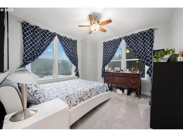 a living room with a bed furniture and a window