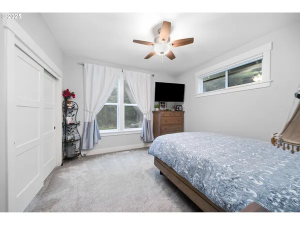 a bedroom with a bed and a flat screen tv