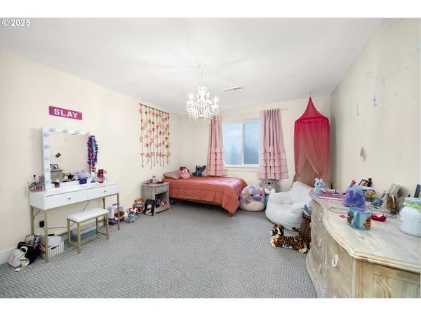 a bedroom with furniture and a chandelier