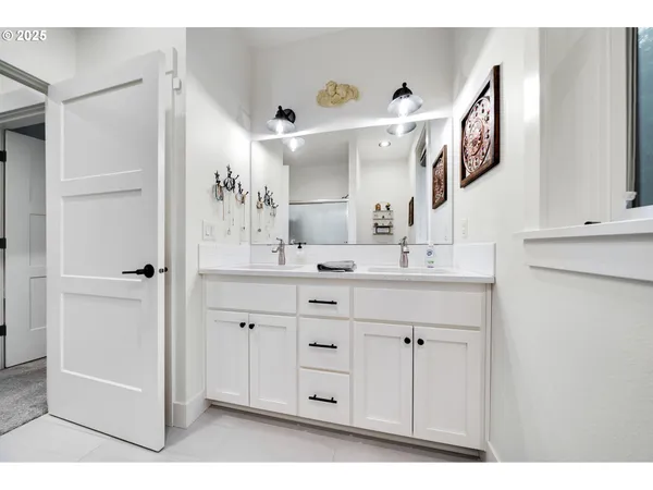 a bathroom with a double vanity sink and a mirror