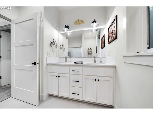 a bathroom with a double vanity sink and a mirror