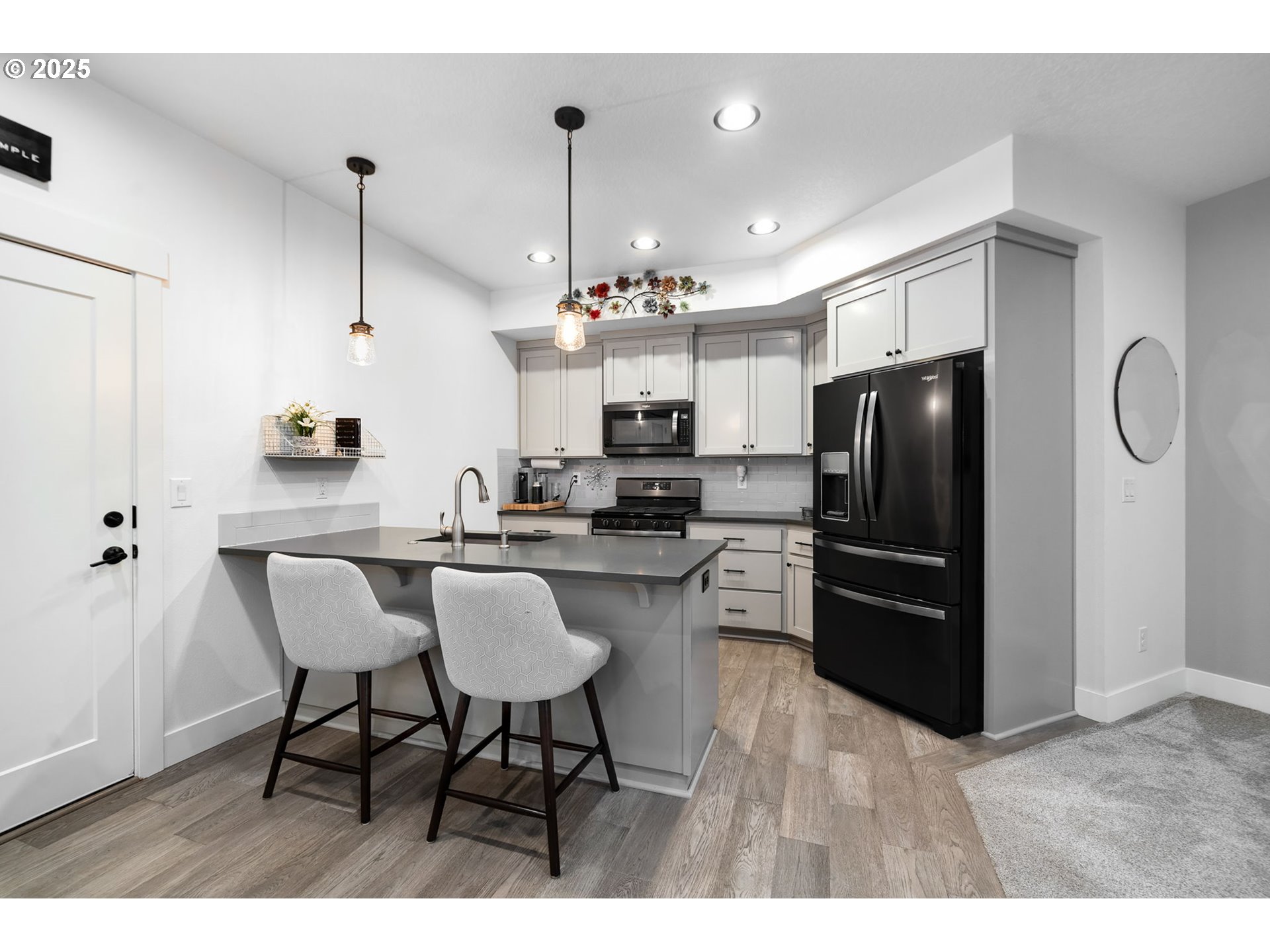 17211 Northeast Yacolt Mountain Road Yacolt, WA 98675 - Photo 33 of 44 a kitchen with stainless steel appliances kitchen island granite countertop a refrigerator a stove a microwave a dining table and chairs