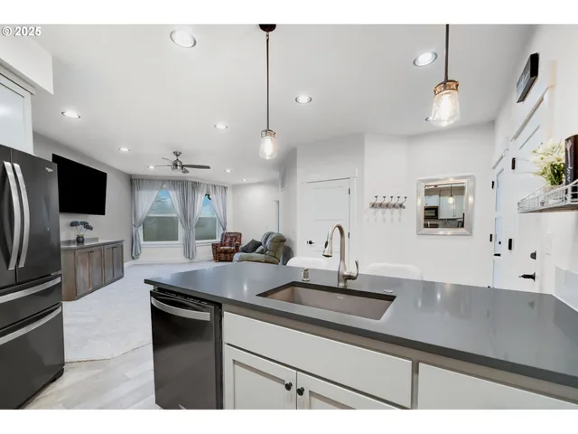 a kitchen with stainless steel appliances a sink stove and refrigerator
