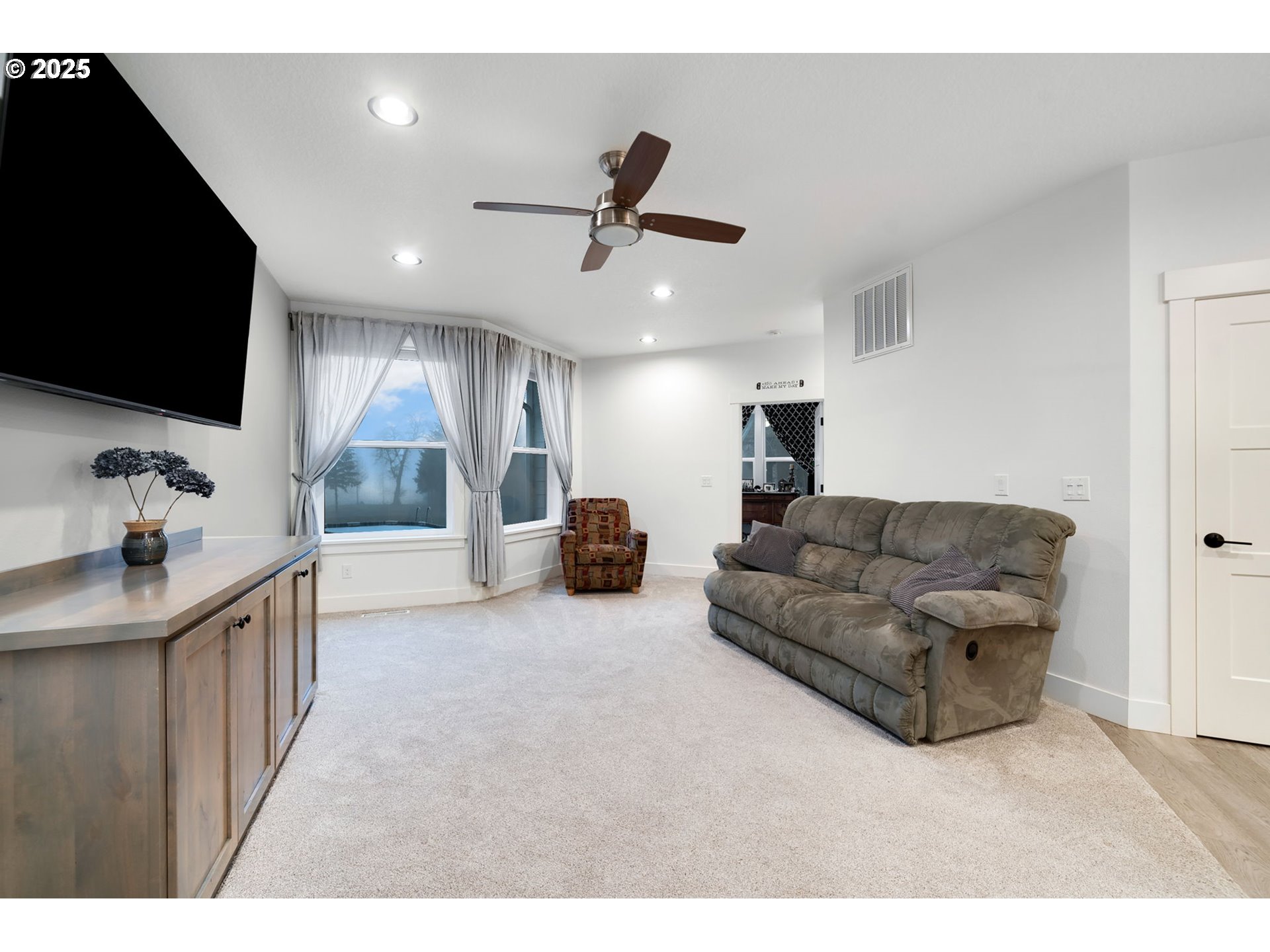 17211 Northeast Yacolt Mountain Road Yacolt, WA 98675 - Photo 36 of 44 a living room with furniture and a flat screen tv