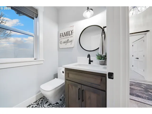 a bathroom with a toilet a sink and a mirror