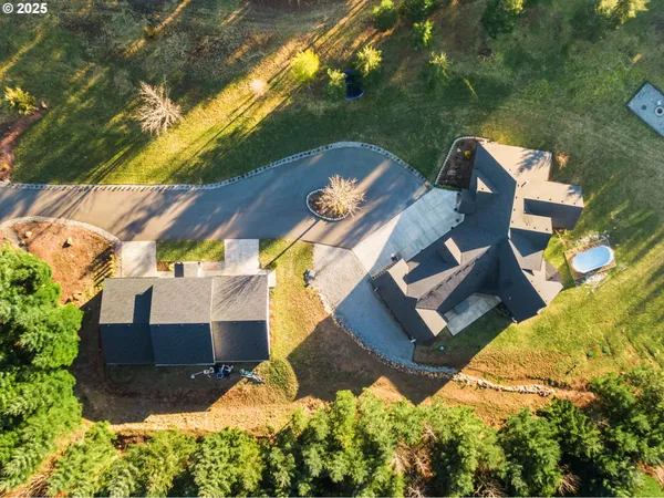 an aerial view of a house with a yard and garden