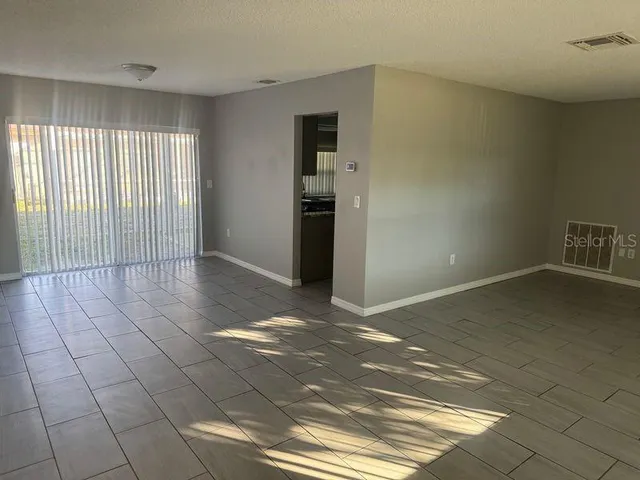 a view of a livingroom with an empty space and a window