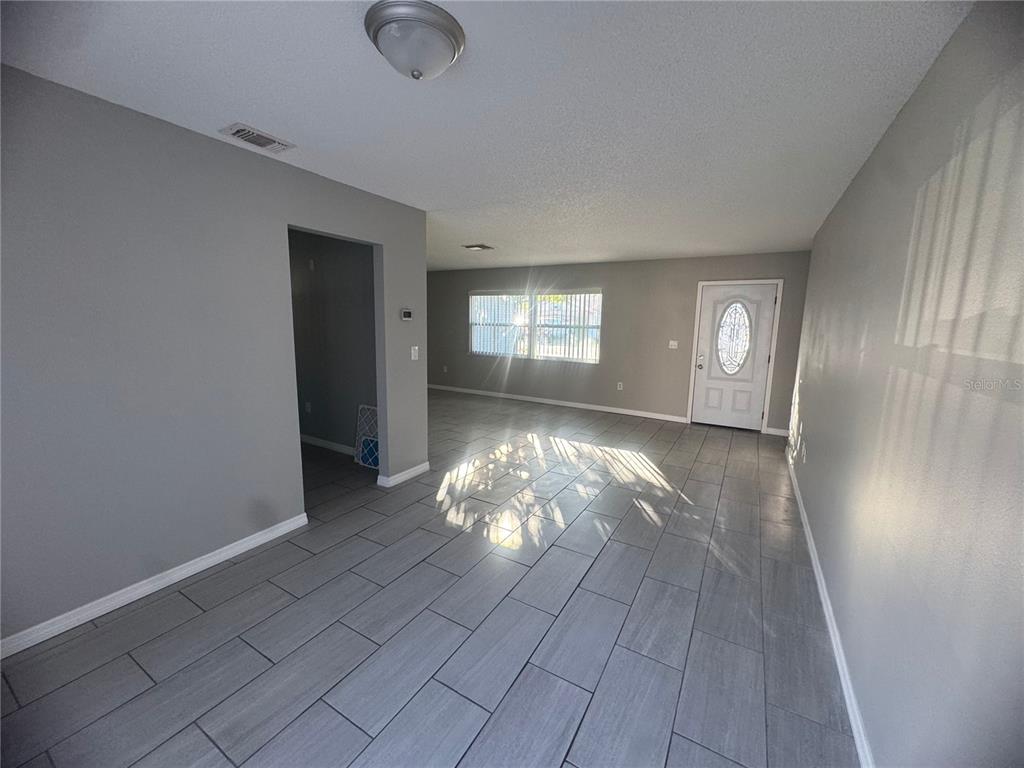 13016 Sirius Lane Hudson, FL 34667 - Photo 8 of 13 an empty room with windows