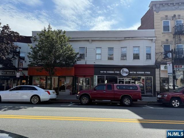 a view of a cars park in front of a building