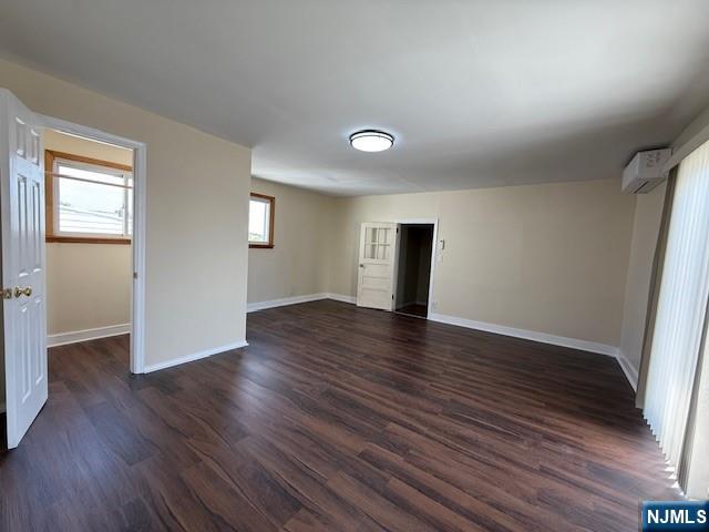 234 Paterson Avenue, Unit 1 East Rutherford, NJ 07073 - Photo 14 of 15 an empty room with wooden floor and windows