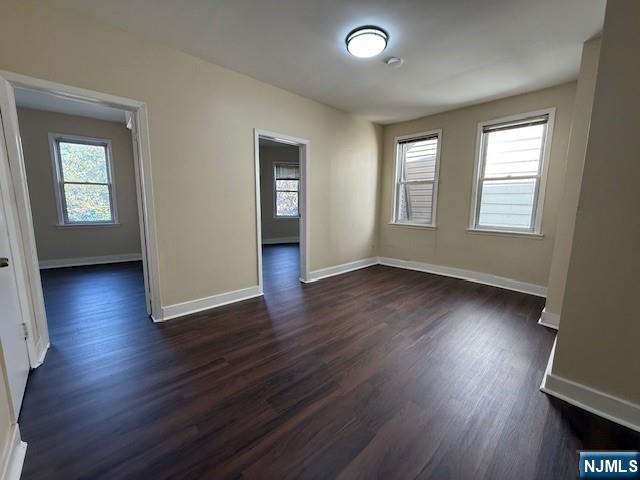 234 Paterson Avenue, Unit 1 East Rutherford, NJ 07073 - Photo 8 of 15 an empty room with wooden floor and windows