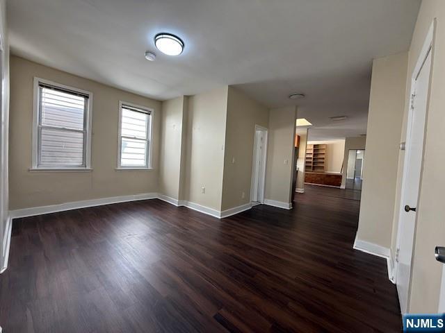 234 Paterson Avenue, Unit 1 East Rutherford, NJ 07073 - Photo 9 of 15 an empty room with wooden floor and windows