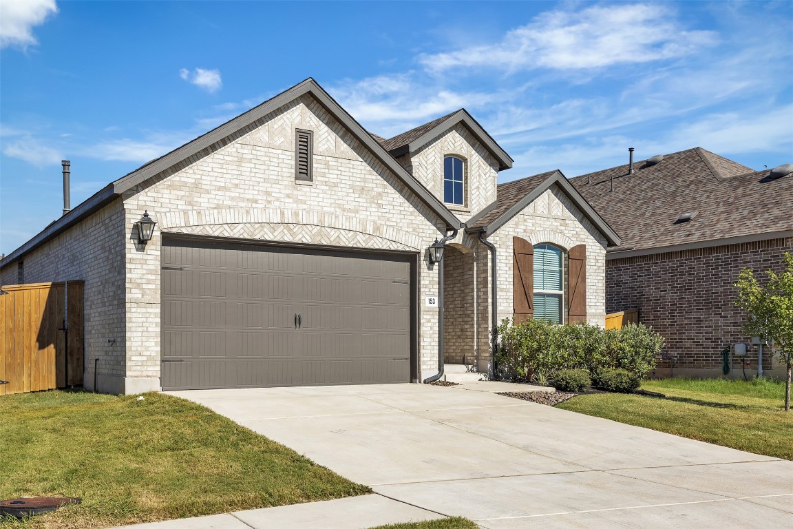 153 Billowing Way Kyle, TX 78640 - Photo 1 of 22 a front view of a house with a garden
