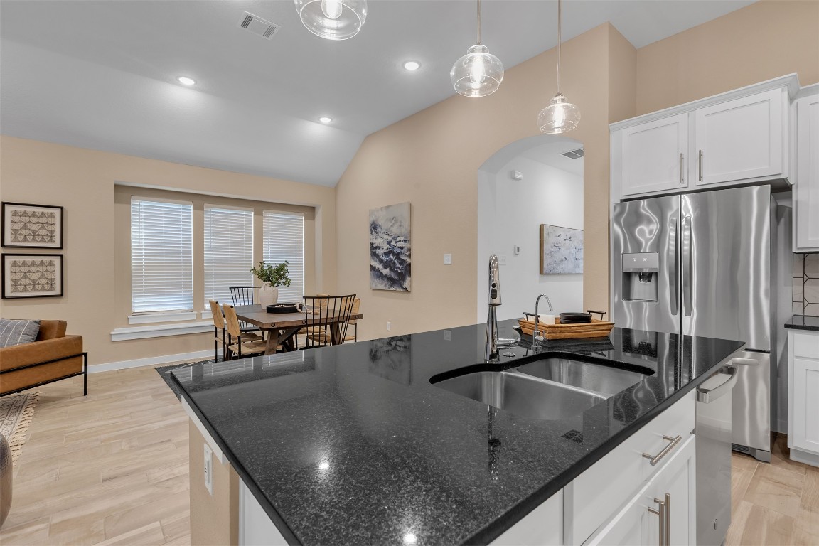 153 Billowing Way Kyle, TX 78640 - Photo 12 of 22 a kitchen with stainless steel appliances granite countertop a sink a stove and a refrigerator