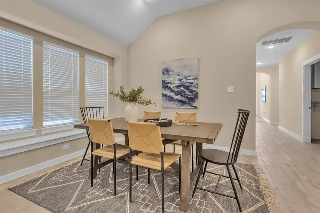 a view of a dining room with furniture and window