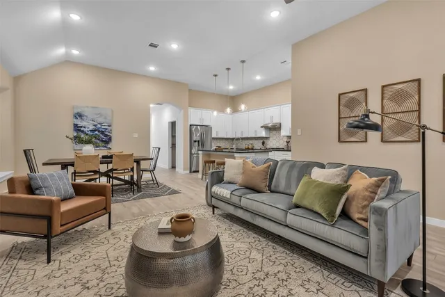 a view of a living room kitchen and a wooden floor