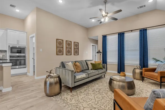 a living room with furniture and a chandelier