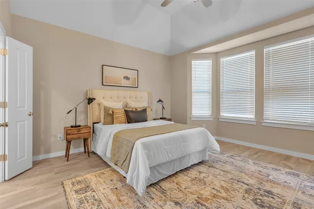 a bedroom with a bed and a window