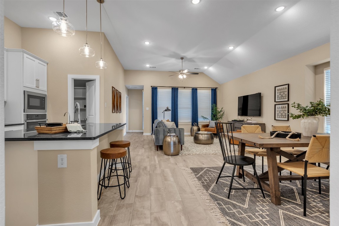 153 Billowing Way Kyle, TX 78640 - Photo 4 of 22 a view of a dining room with furniture window and wooden floor