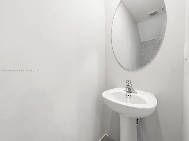 a bathroom with a sink a mirror and vanity