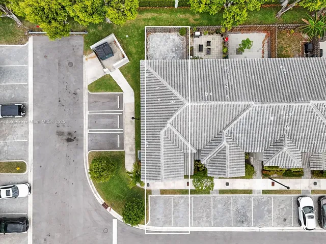 a view of a brick house with wooden fence