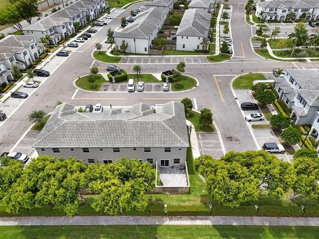 an aerial view of multiple houses with a yard