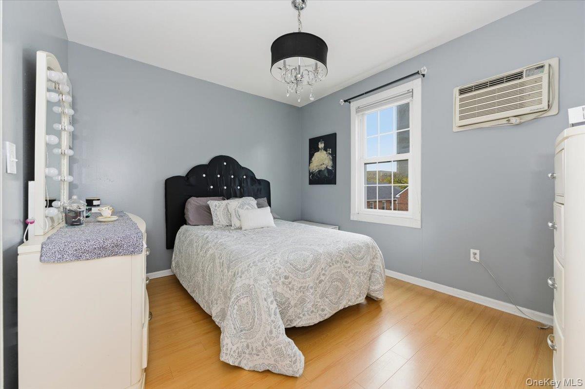 1617 Mahan Avenue Bronx, NY 10461 - Photo 13 of 29 a bedroom with a bed and a chandelier