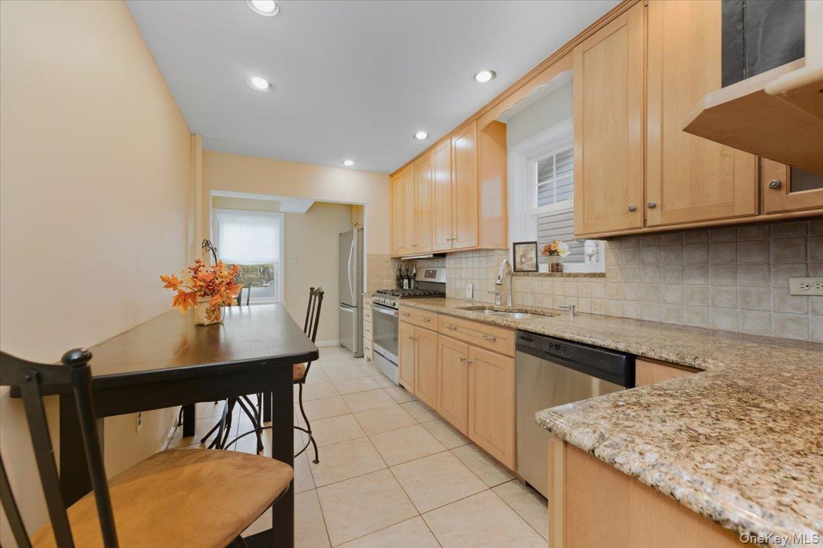 1617 Mahan Avenue Bronx, NY 10461 - Photo 9 of 29 a kitchen with stainless steel appliances granite countertop a stove a sink a microwave and a dining table