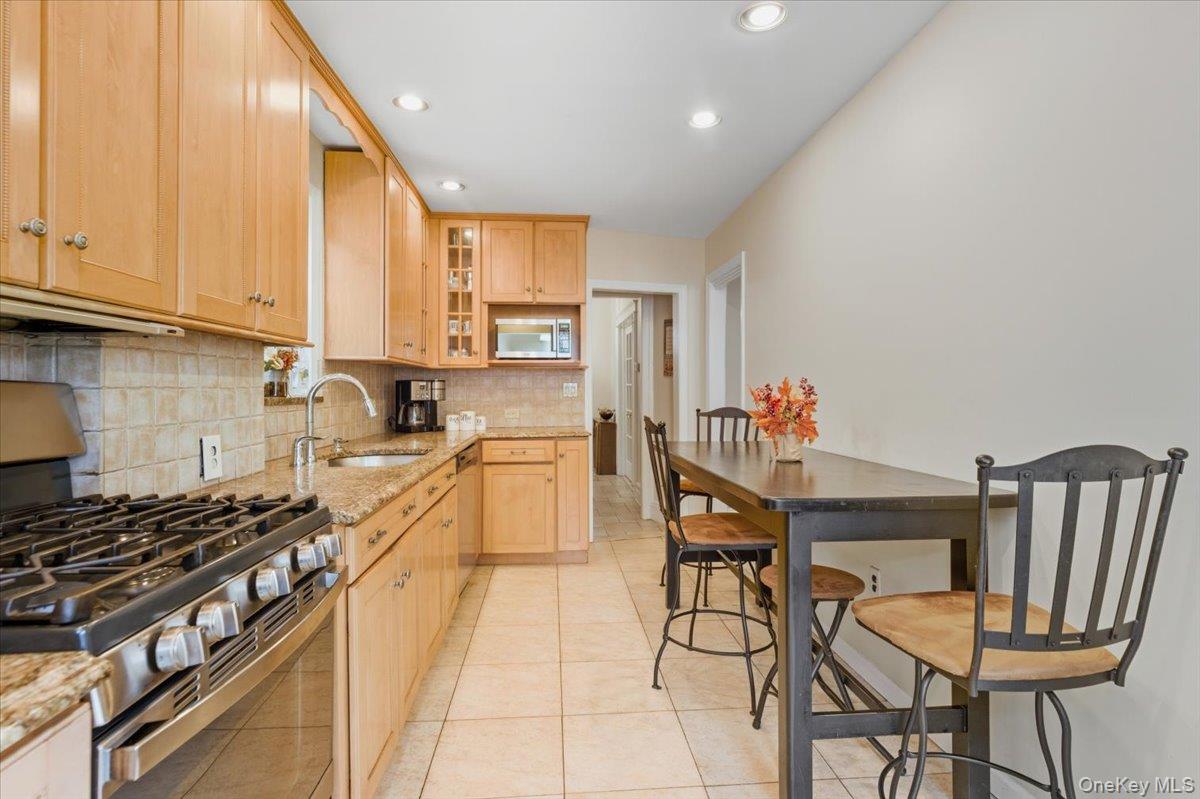 1617 Mahan Avenue Bronx, NY 10461 - Photo 10 of 29 a kitchen with stainless steel appliances granite countertop a stove a sink dishwasher and cabinets