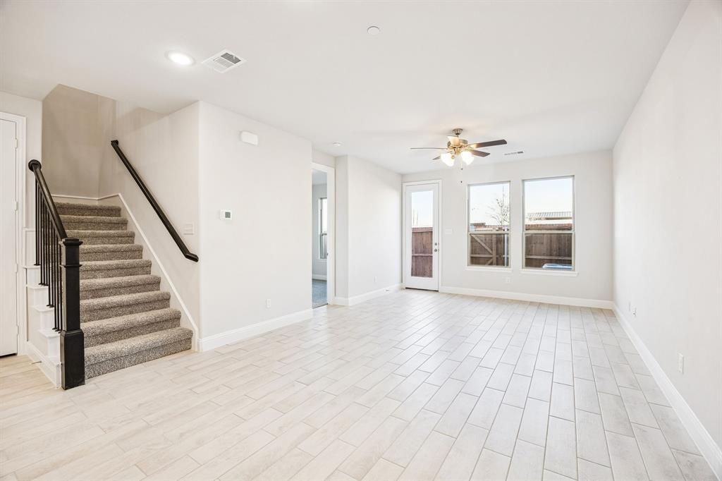 912 Heart Reef Road Plano, TX 75075 - Photo 8 of 20 a view of an empty room with wooden floor and a window