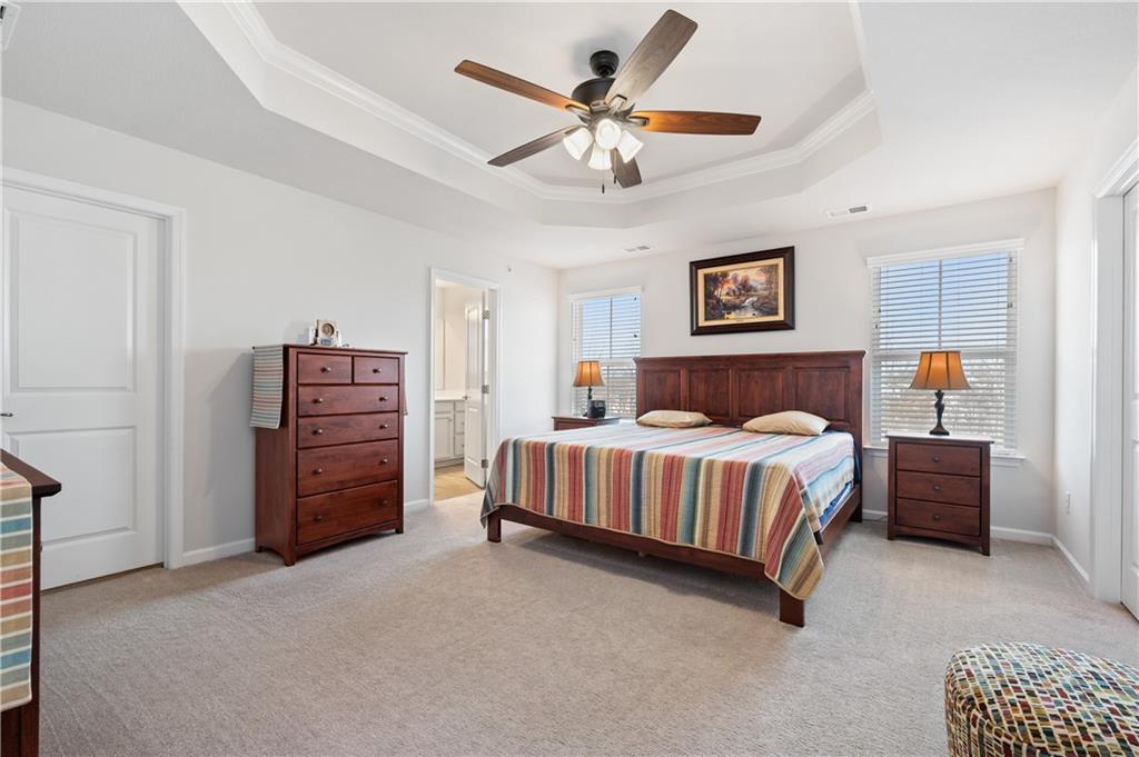 238 Frances Lane McDonald, PA 15057 - Photo 10 of 30 a spacious bedroom with a bed and a ceiling fan