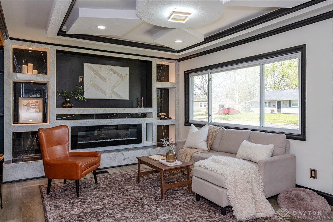 5240 Haverfield Road Dayton, OH 45432 - Photo 7 of 58 This living room features a modern fireplace, offering a blend of comfort and contemporary design.